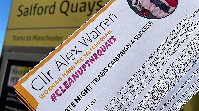 Image showing a leaflet from Alex Warren about the successful campaign to bring late night trams into Salford. A Metrolink Tram stop showing 'Salford Quays' is in the background.
